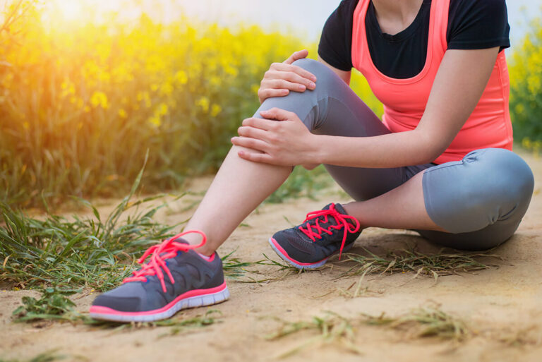 Woman with knee pain sitting down